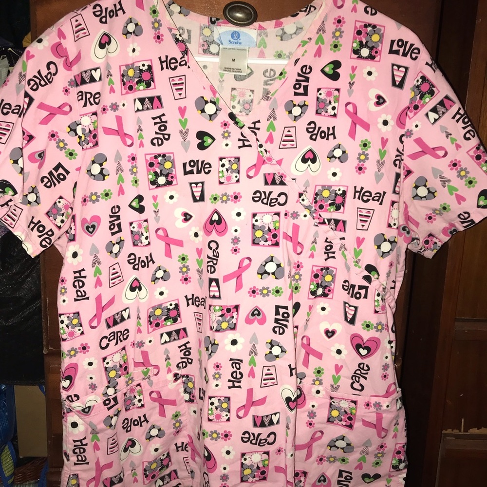 Pink woman’s scrub top with Brest cancer awareness ribbon and hearts